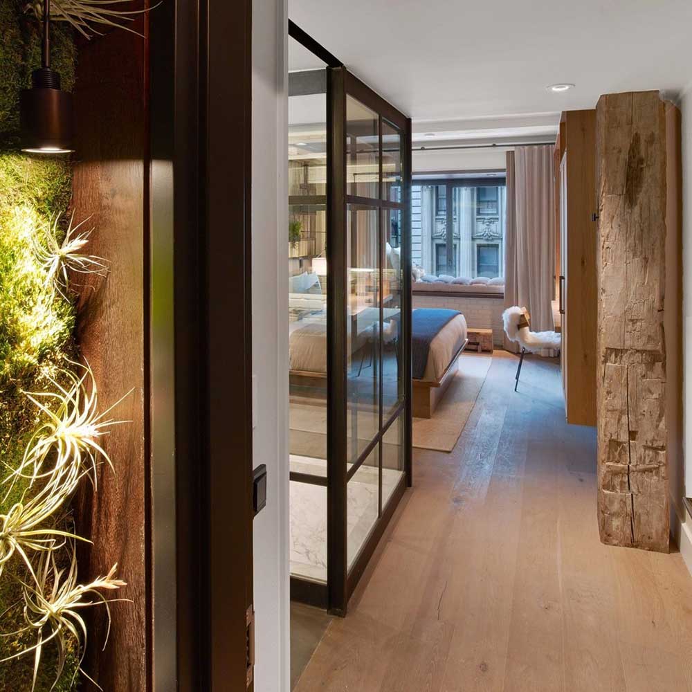 guest room at a luxury hotel features potted plants that serve as natural air purifiers