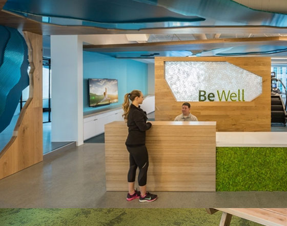 welcome desk with a plant wall and grassy green carpet