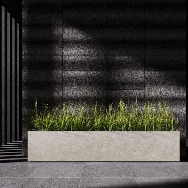 A rectangular planter in a light neutral tone filled with ornamental grasses