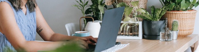 a woman studying results of client surveys on her computer