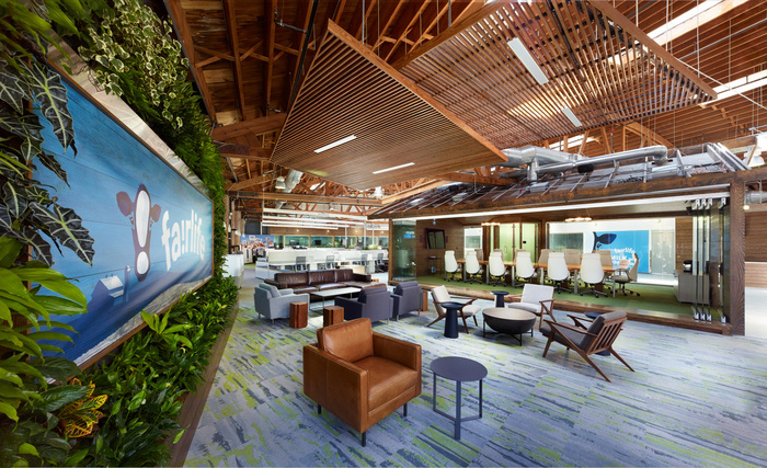 office lobby with green wall and natural wood interior showcasing biophilic design in the workplace